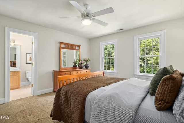 4021 Chaumont Dr, Apex, NC 27539 - bedroom with light colored carpet, baseboards, connected bathroom, and a ceiling fan