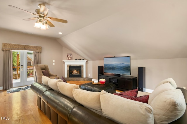 4021 Chaumont Dr, Apex, NC 27539 - living area with ceiling fan, light wood-style flooring, lofted ceiling, a tiled fireplace, and baseboards