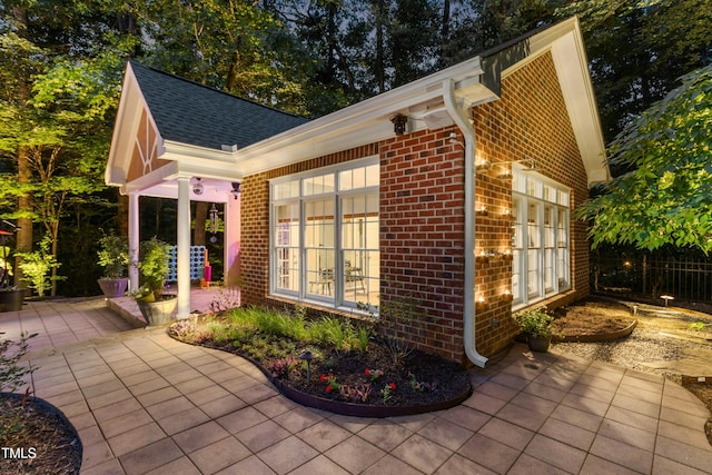 4021 Chaumont Dr, Apex, NC 27539 - view of home's exterior with brick siding, a patio area, and a shingled roof