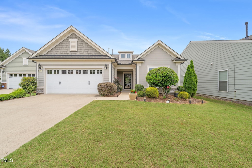 104 Spindle Dr, Durham, NC 27703 - view of front of home featuring an attached garage, driveway, and a front lawn