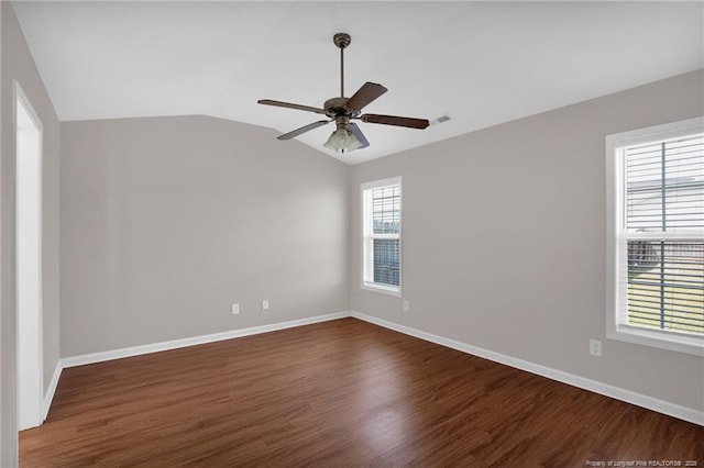 2554 Hunting Bow Dr, Hope Mills, NC 28348 - spare room with dark wood-style floors, a ceiling fan, baseboards, and vaulted ceiling