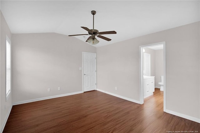 2554 Hunting Bow Dr, Hope Mills, NC 28348 - spare room with a ceiling fan, dark wood-style flooring, plenty of natural light, baseboards, and vaulted ceiling