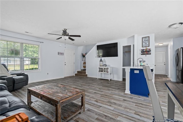 332 Dundee Cir, Raeford, NC 28376 - living room with ceiling fan, wood finished floors, baseboards, and stairs