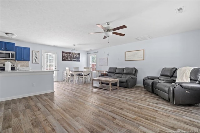 332 Dundee Cir, Raeford, NC 28376 - living area with light wood-style floors, ceiling fan, and baseboards