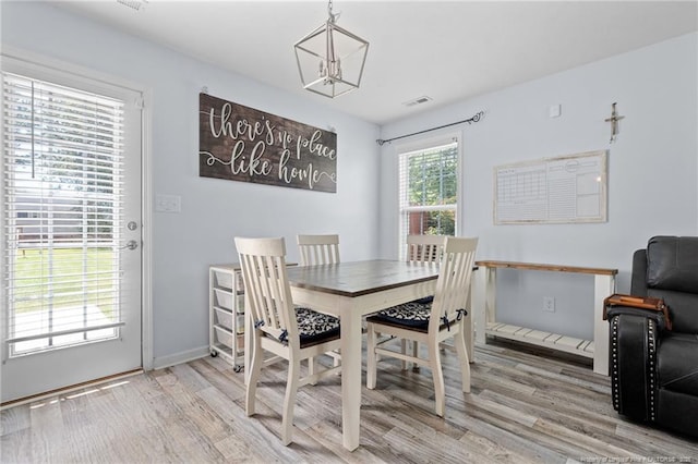 332 Dundee Cir, Raeford, NC 28376 - dining space featuring wood finished floors, baseboards, and a chandelier