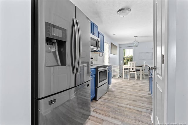 332 Dundee Cir, Raeford, NC 28376 - kitchen with blue cabinets, appliances with stainless steel finishes, and light wood-type flooring