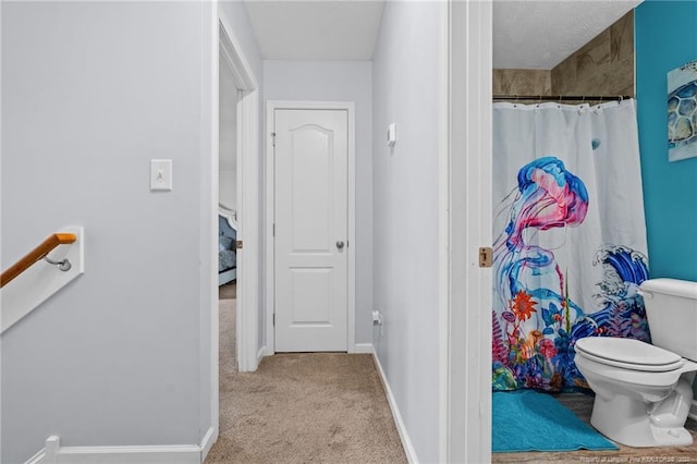 332 Dundee Cir, Raeford, NC 28376 - bathroom with toilet, baseboards, a shower with shower curtain, and a textured ceiling