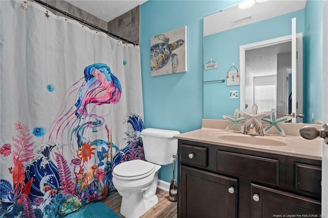 332 Dundee Cir, Raeford, NC 28376 - full bath featuring toilet, vanity, wood finished floors, a textured ceiling, and a shower with curtain