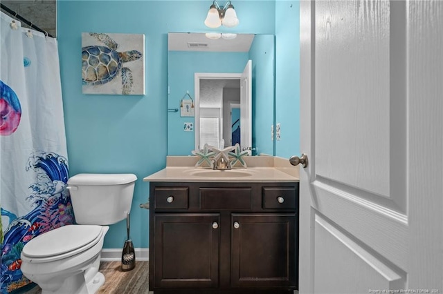 332 Dundee Cir, Raeford, NC 28376 - full bath featuring toilet, vanity, wood finished floors, baseboards, and curtained shower