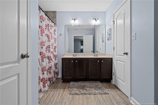332 Dundee Cir, Raeford, NC 28376 - full bath with wood finished floors, double vanity, curtained shower, and baseboards