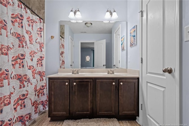 332 Dundee Cir, Raeford, NC 28376 - full bath with double vanity, wood finished floors, and curtained shower