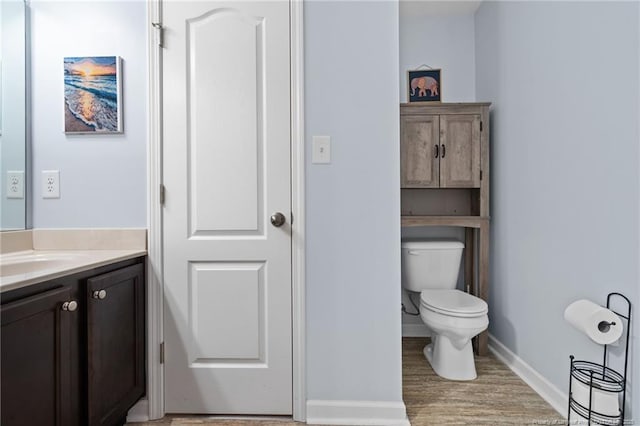 332 Dundee Cir, Raeford, NC 28376 - bathroom featuring vanity, toilet, baseboards, and wood finished floors