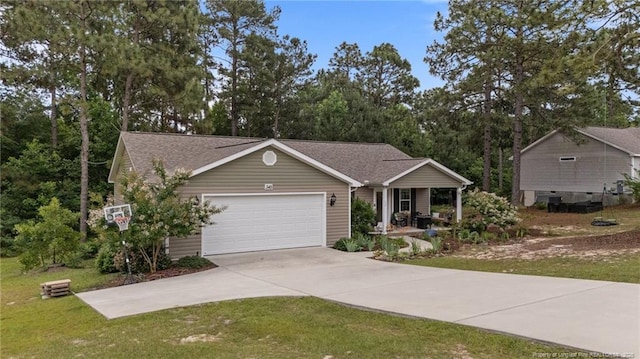345 Pickett Cir, Vass, NC 28394 - view of front of property featuring driveway, a garage, a front lawn, and a porch