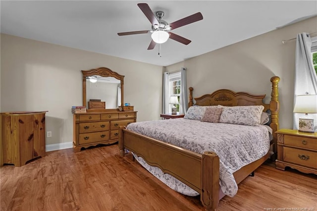 345 Pickett Cir, Vass, NC 28394 - bedroom with light wood-type flooring, a ceiling fan, and baseboards