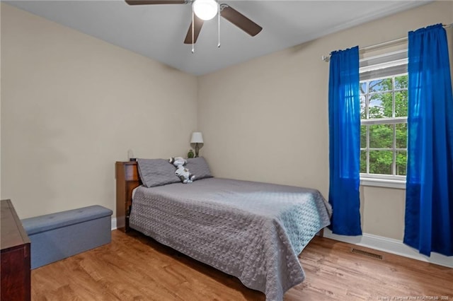 345 Pickett Cir, Vass, NC 28394 - bedroom with wood finished floors, a ceiling fan, and baseboards
