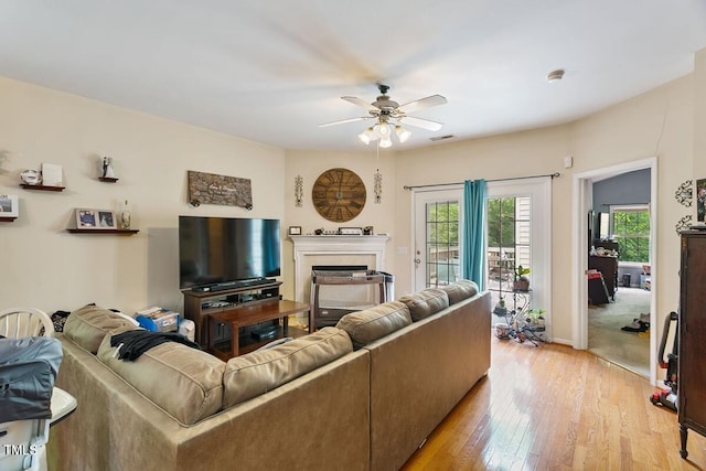 320 Madres Ln, Morrisville, NC 27560 - living area with a ceiling fan, light wood-style floors, a fireplace, and baseboards