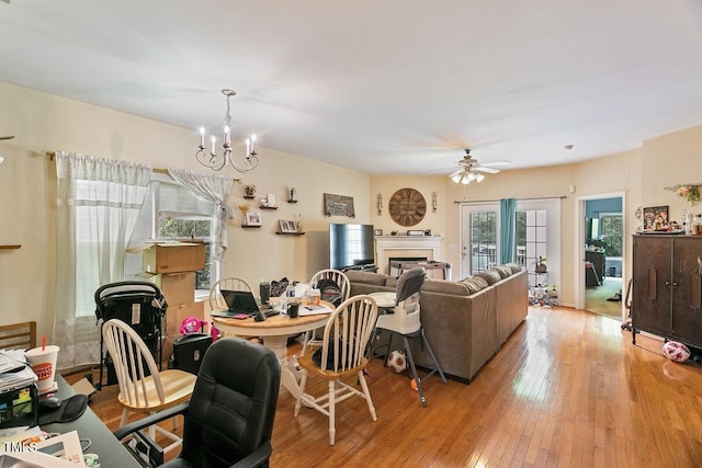 320 Madres Ln, Morrisville, NC 27560 - dining room featuring ceiling fan, a chandelier, a glass covered fireplace, and hardwood / wood-style flooring
