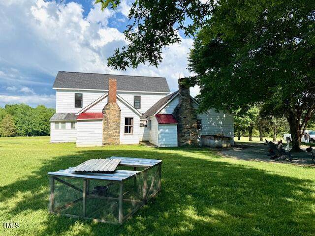8365 Aaron Creek Church Rd, Oxford, NC 27565 - rear view of property featuring a lawn and a chimney
