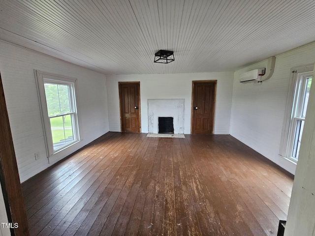 8365 Aaron Creek Church Rd, Oxford, NC 27565 - unfurnished living room featuring hardwood / wood-style flooring, a fireplace, and a wall unit AC