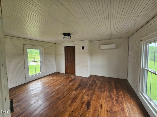 8365 Aaron Creek Church Rd, Oxford, NC 27565 - empty room with a wall unit AC, hardwood / wood-style flooring, plenty of natural light, and wood walls