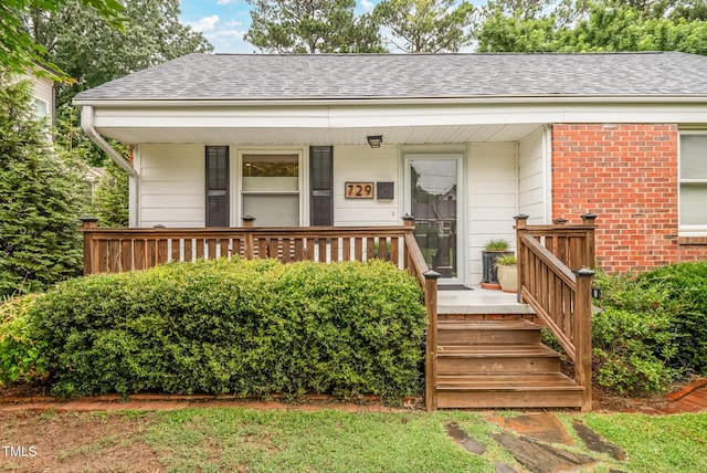 729 Mial St, Raleigh, NC 27608 - view of front of property featuring a shingled roof and brick siding