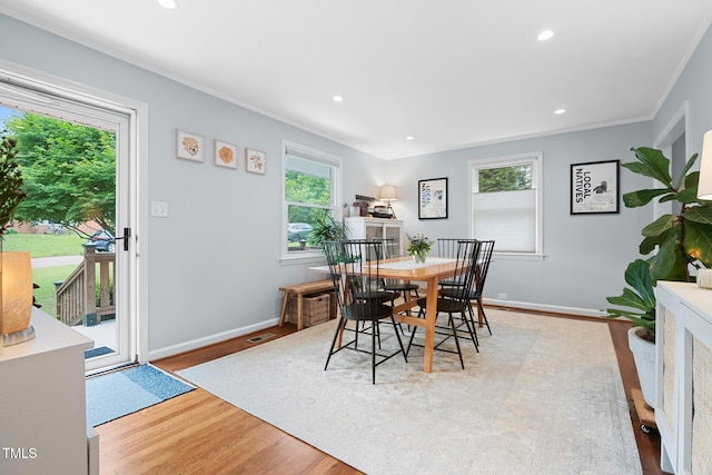 729 Mial St, Raleigh, NC 27608 - dining space with crown molding, wood finished floors, baseboards, and recessed lighting