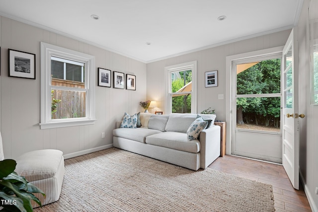 729 Mial St, Raleigh, NC 27608 - living area featuring ornamental molding, light wood-style floors, a decorative wall, and baseboards