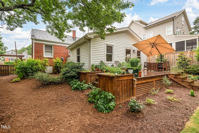 729 Mial St, Raleigh, NC 27608 - rear view of property featuring a deck, brick siding, and a chimney