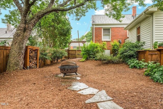 729 Mial St, Raleigh, NC 27608 - fenced backyard with a fire pit