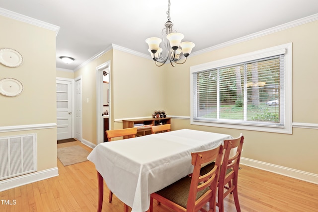 2805 Friendship Rd, Durham, NC 27705 - dining room with a chandelier, light wood-style floors, baseboards, and ornamental molding