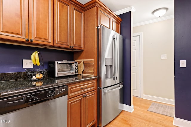 2805 Friendship Rd, Durham, NC 27705 - kitchen with stainless steel appliances, ornamental molding, brown cabinets, light wood-type flooring, and baseboards
