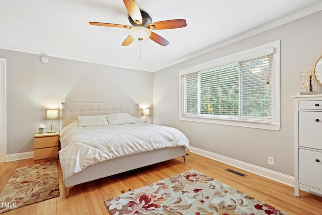 2805 Friendship Rd, Durham, NC 27705 - bedroom featuring crown molding, baseboards, light wood finished floors, and a ceiling fan