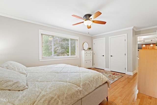 2805 Friendship Rd, Durham, NC 27705 - bedroom with light wood-style flooring, ornamental molding, ceiling fan, multiple closets, and baseboards