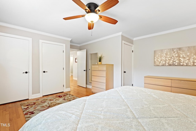 2805 Friendship Rd, Durham, NC 27705 - bedroom with wood finished floors, crown molding, multiple closets, a ceiling fan, and baseboards