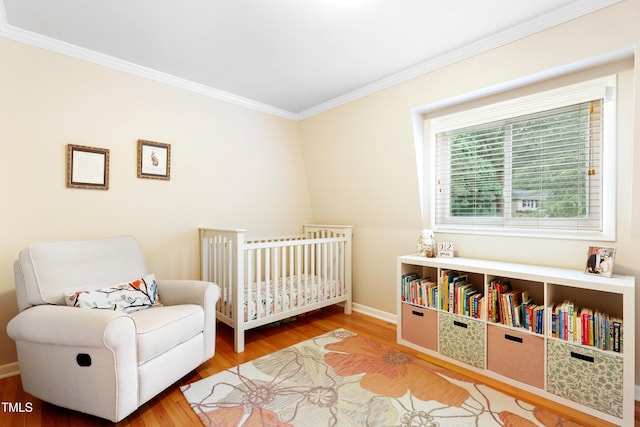 2805 Friendship Rd, Durham, NC 27705 - bedroom with crown molding, wood finished floors, baseboards, and a nursery area