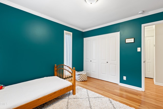 2805 Friendship Rd, Durham, NC 27705 - bedroom featuring wood finished floors, a closet, ornamental molding, and baseboards