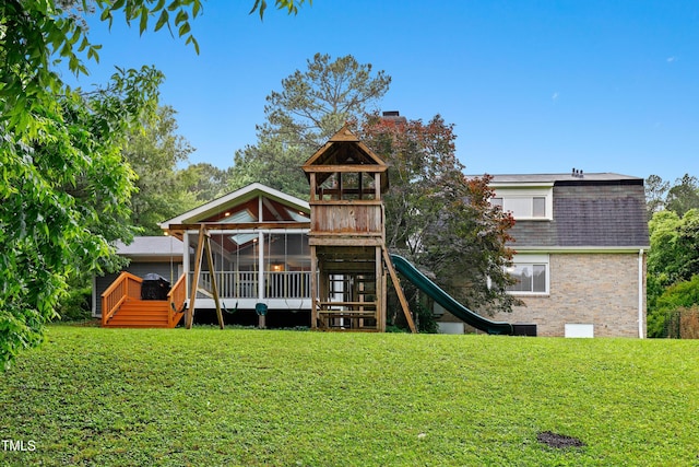 2805 Friendship Rd, Durham, NC 27705 - rear view of house featuring a playground, a lawn, a deck, and brick siding