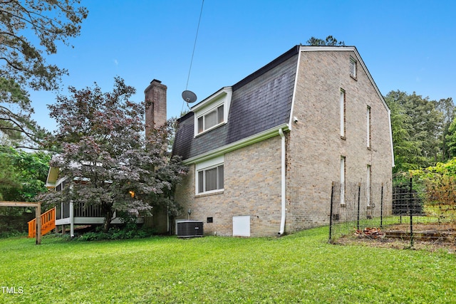 2805 Friendship Rd, Durham, NC 27705 - rear view of property featuring central AC, a chimney, a lawn, roof with shingles, and a deck