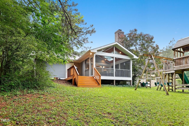 2805 Friendship Rd, Durham, NC 27705 - back of property featuring a sunroom, a chimney, a lawn, stairway, and a playground