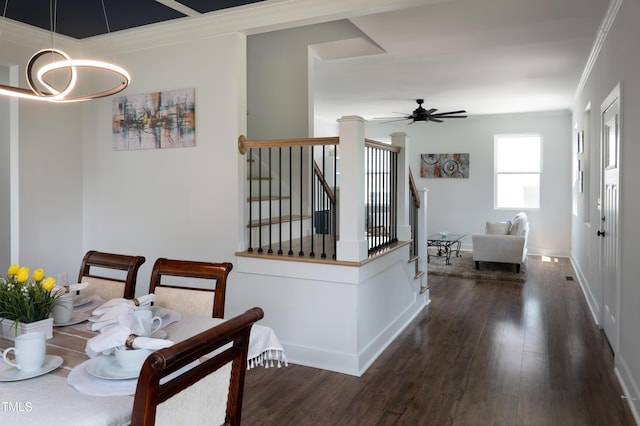 2517 Newbold St, Raleigh, NC 27603 - dining room with crown molding, dark wood-style flooring, a ceiling fan, baseboards, and a chandelier