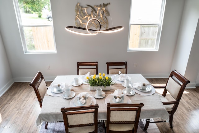2517 Newbold St, Raleigh, NC 27603 - dining space with wood finished floors, a chandelier, and baseboards
