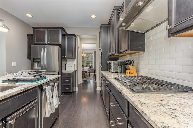 352 Fire Opal Ln, Holly Springs, NC 27540 - kitchen featuring stainless steel appliances, custom exhaust hood, backsplash, dark wood-style floors, and light stone counters