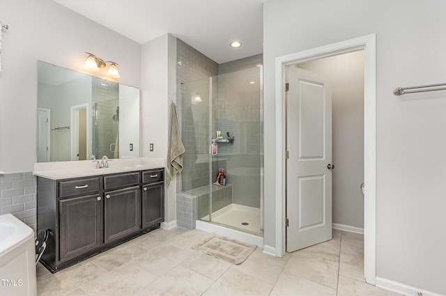 352 Fire Opal Ln, Holly Springs, NC 27540 - full bathroom with vanity, a shower stall, baseboards, recessed lighting, and a tub to relax in