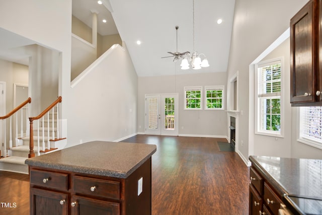 106 Gumdrop Path, Apex, NC 27502 - living area with high vaulted ceiling, stairway, a chandelier, dark wood-style floors, and baseboards