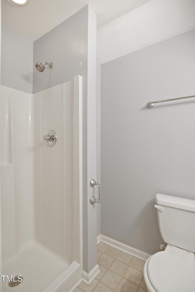 106 Gumdrop Path, Apex, NC 27502 - bathroom featuring baseboards, a shower stall, toilet, and tile patterned floors