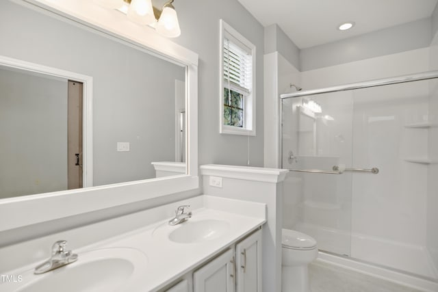 106 Gumdrop Path, Apex, NC 27502 - bathroom featuring a shower stall, double vanity, and toilet