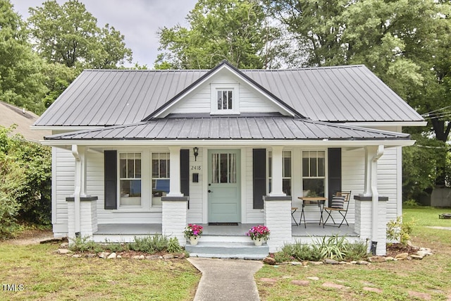 2418 Highland Ave, Durham, NC 27704 - bungalow-style home featuring covered porch, metal roof, and a front lawn