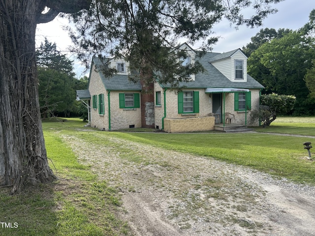45 Perkinson St, Kittrell, NC 27544 - view of front facade with a shingled roof, a front lawn, and stucco siding
