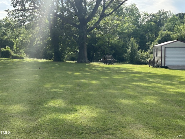 45 Perkinson St, Kittrell, NC 27544 - view of grassy yard with an outbuilding