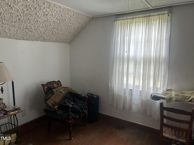 45 Perkinson St, Kittrell, NC 27544 - living area with lofted ceiling, wood finished floors, and baseboards
